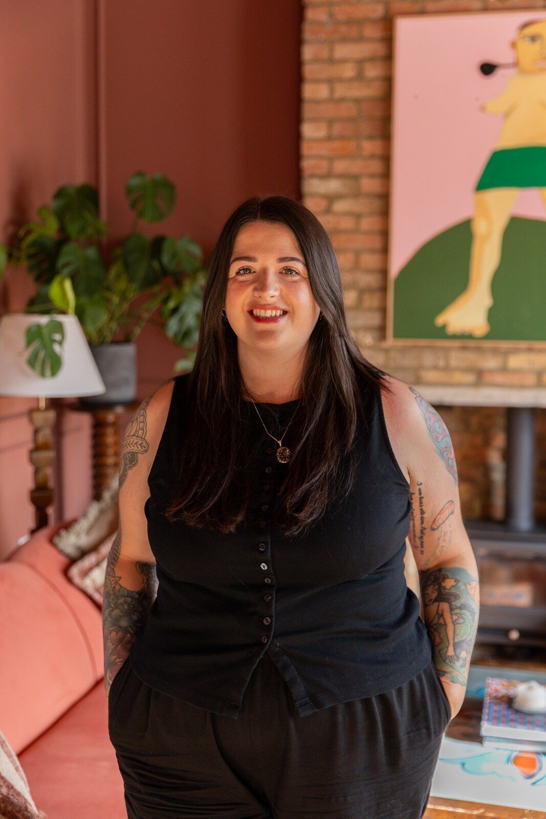 Hannah Wild standing and smiling in her counselling room